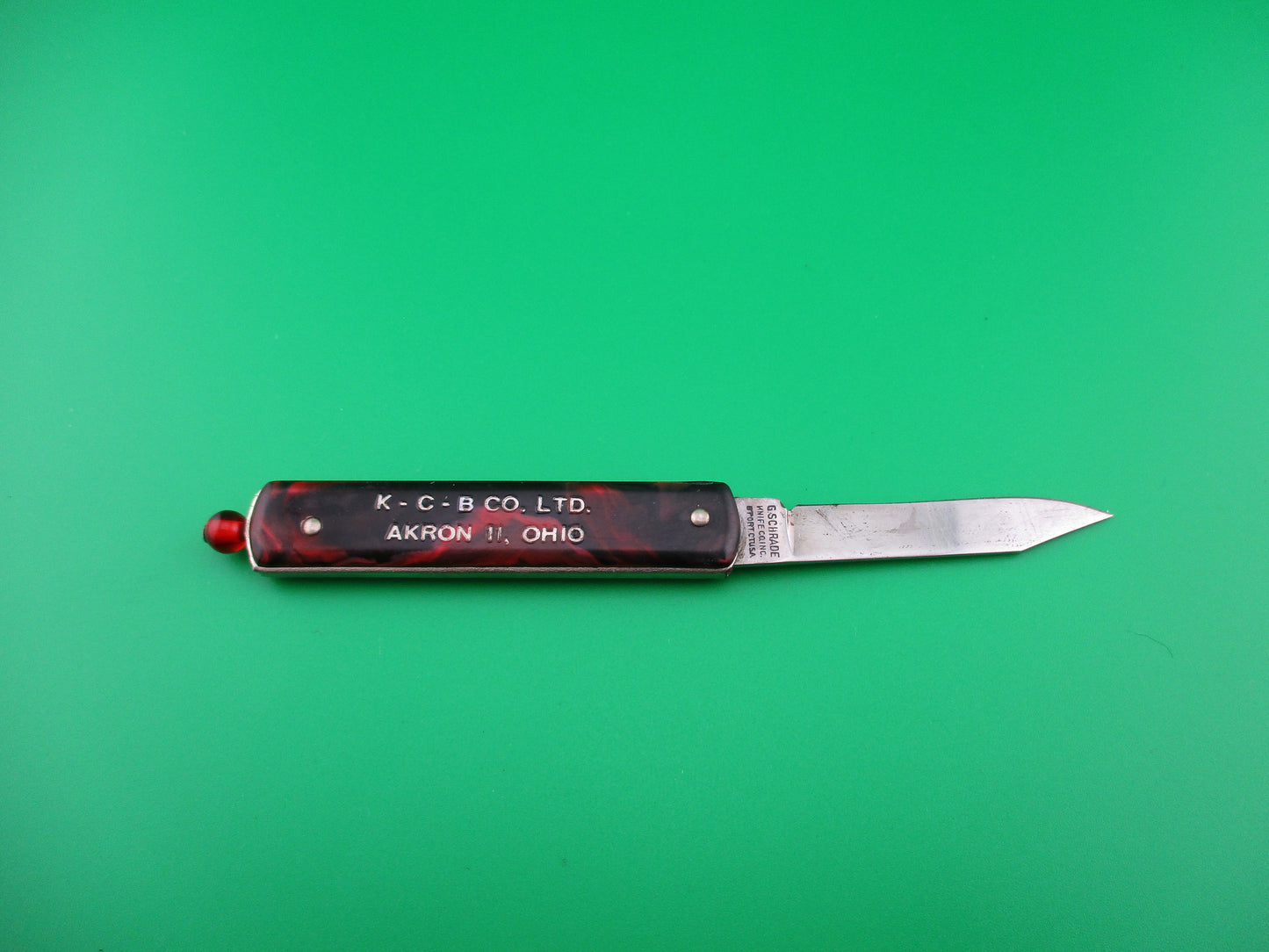 GEORGE SCHRADE KNIFE CO Pullball Red swirl switchblade knife w/sheath