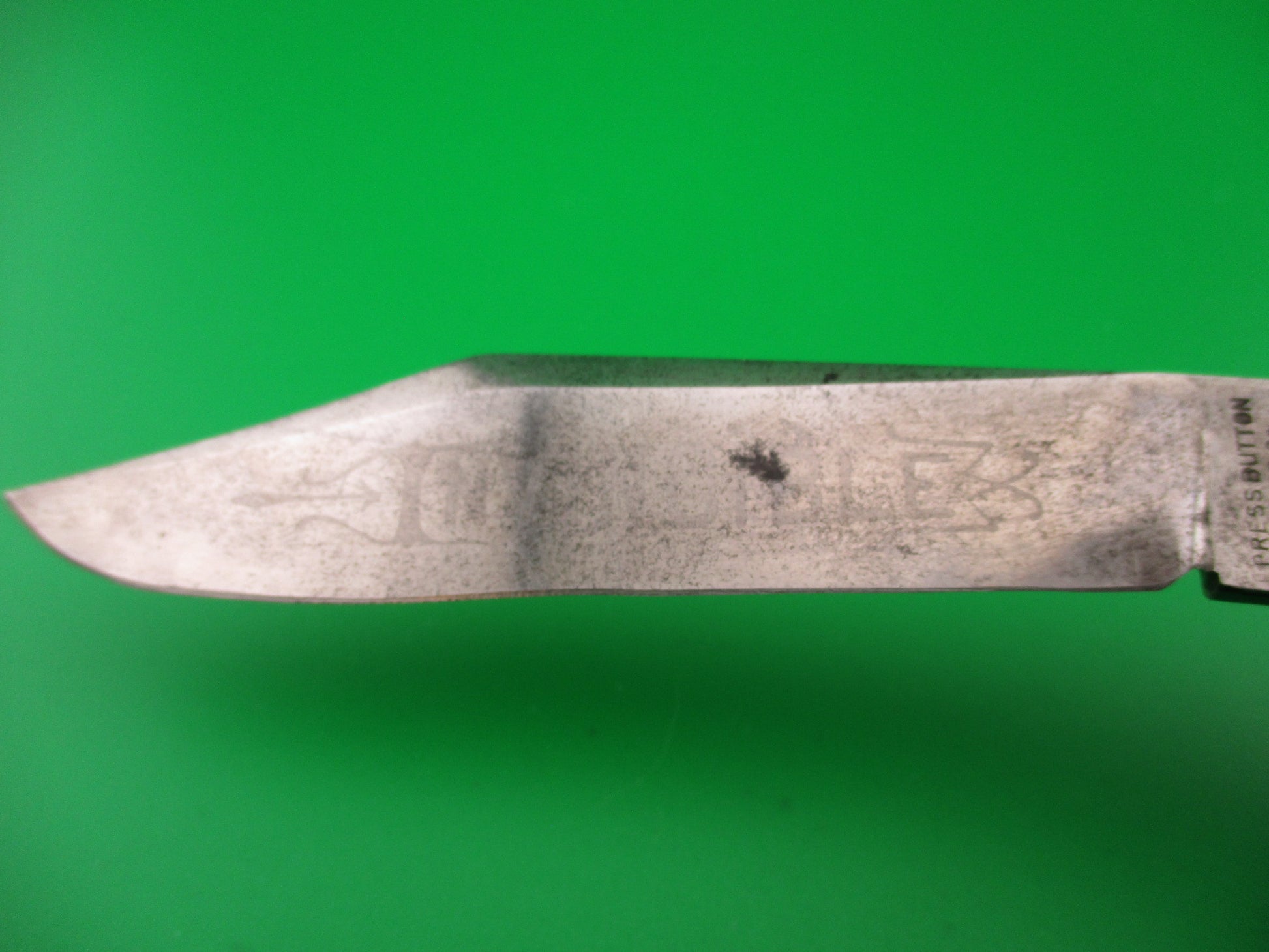 Knife blade on a green background