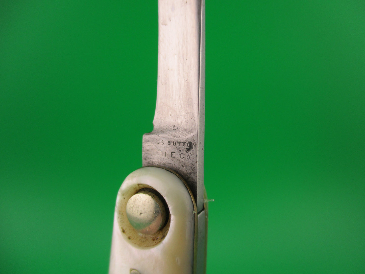 Close-up of a pair of knife with a green background