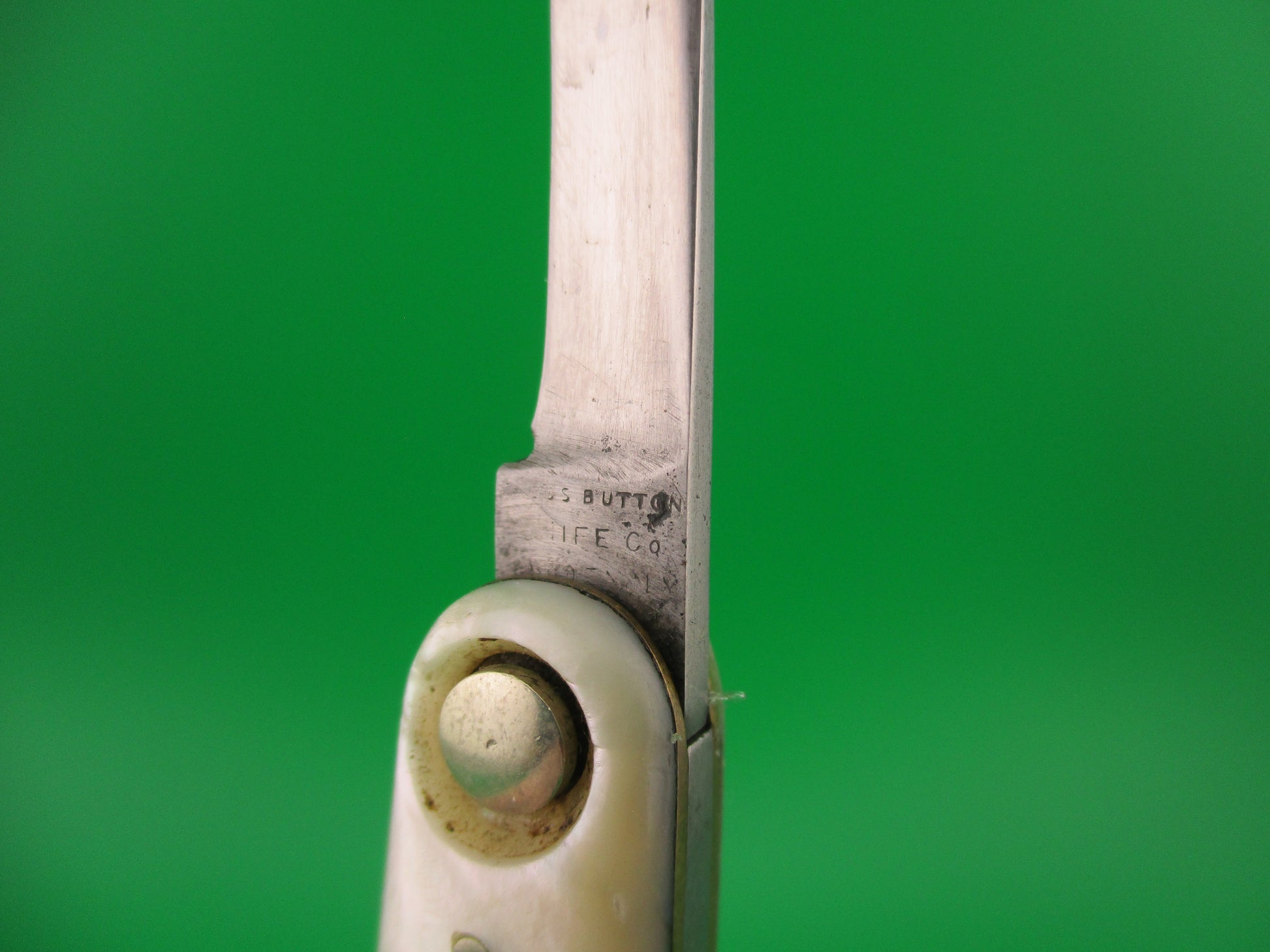 Close-up of a pair of knife with a green background