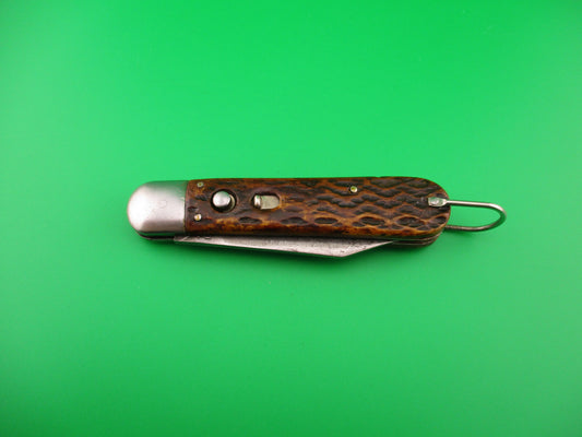 pocket knife with metal blade on a green background