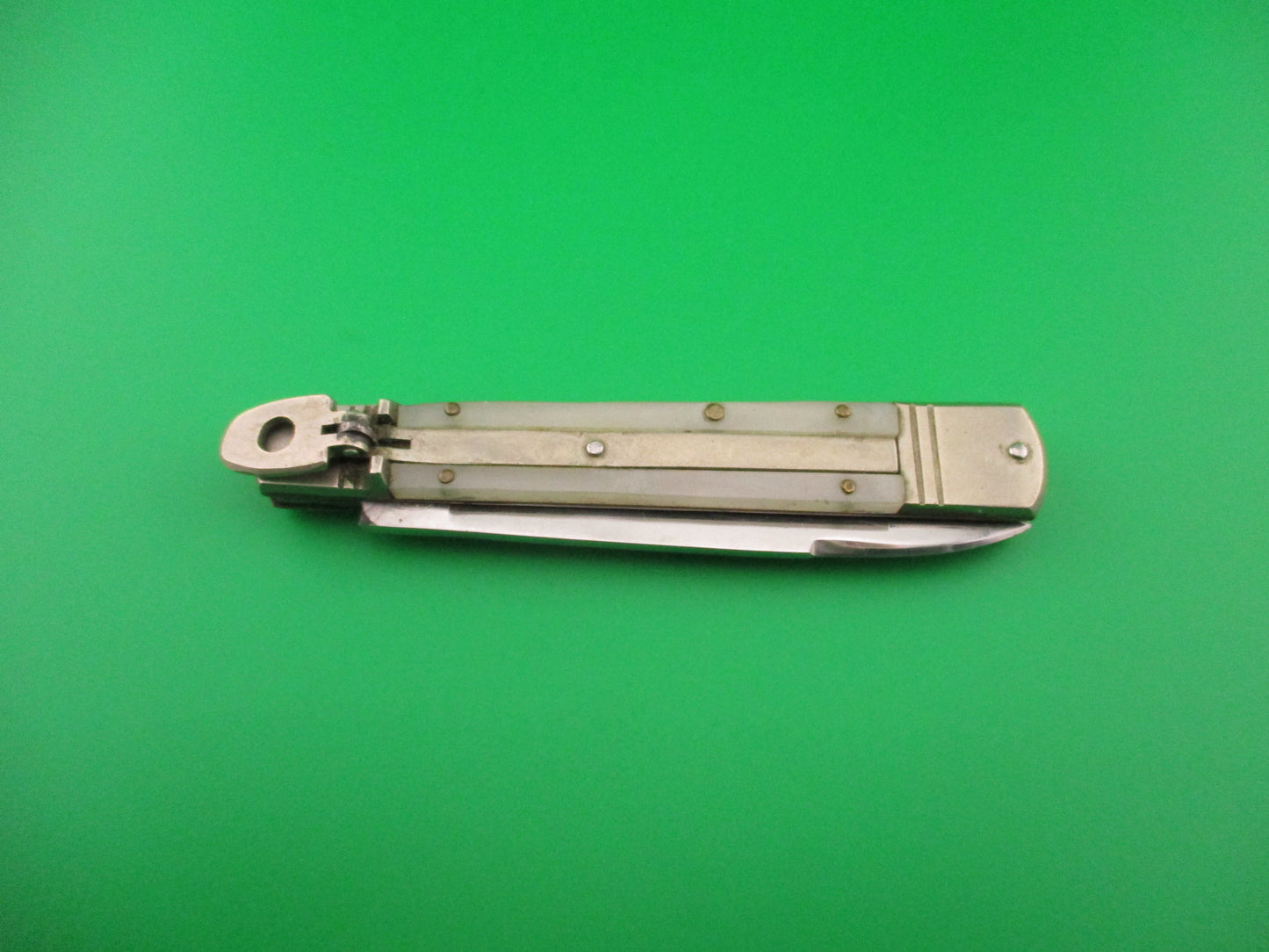 Folding knife on a green background