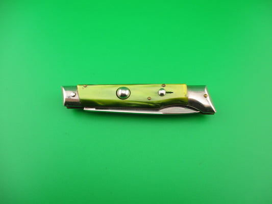 Folding knife with green handle and silver blade on a green background