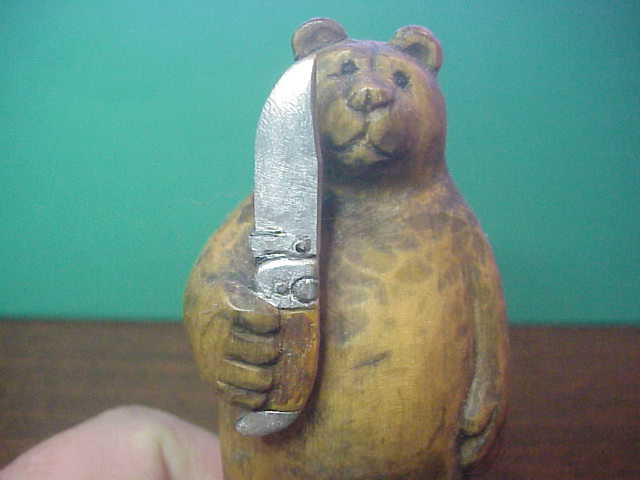 Hand Carved Grizzly Bear holding Kabar Grizzly knife by Bill Horgos