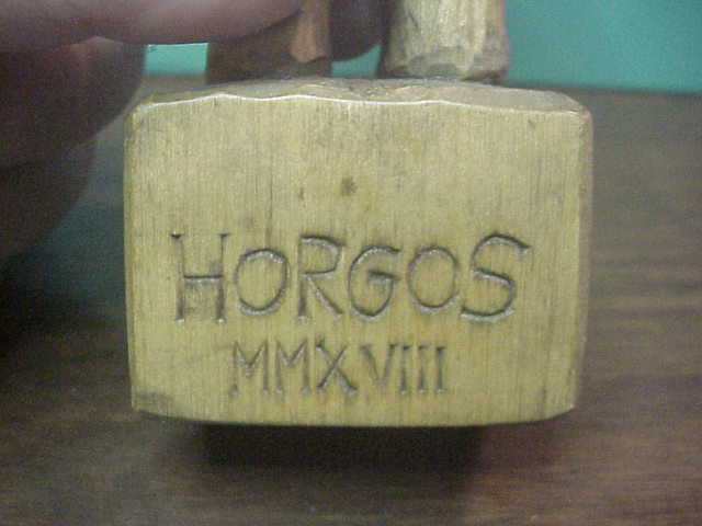 Hand Carved Grizzly Bear holding Kabar Grizzly knife by Bill Horgos