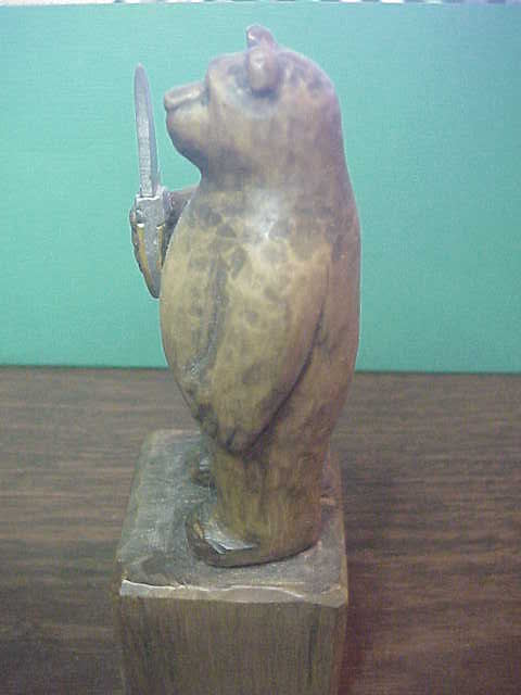 Hand Carved Grizzly Bear holding Kabar Grizzly knife by Bill Horgos