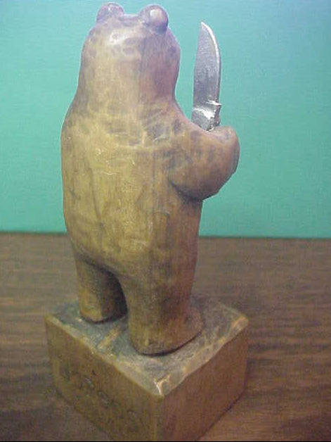 Hand Carved Grizzly Bear holding Kabar Grizzly knife by Bill Horgos